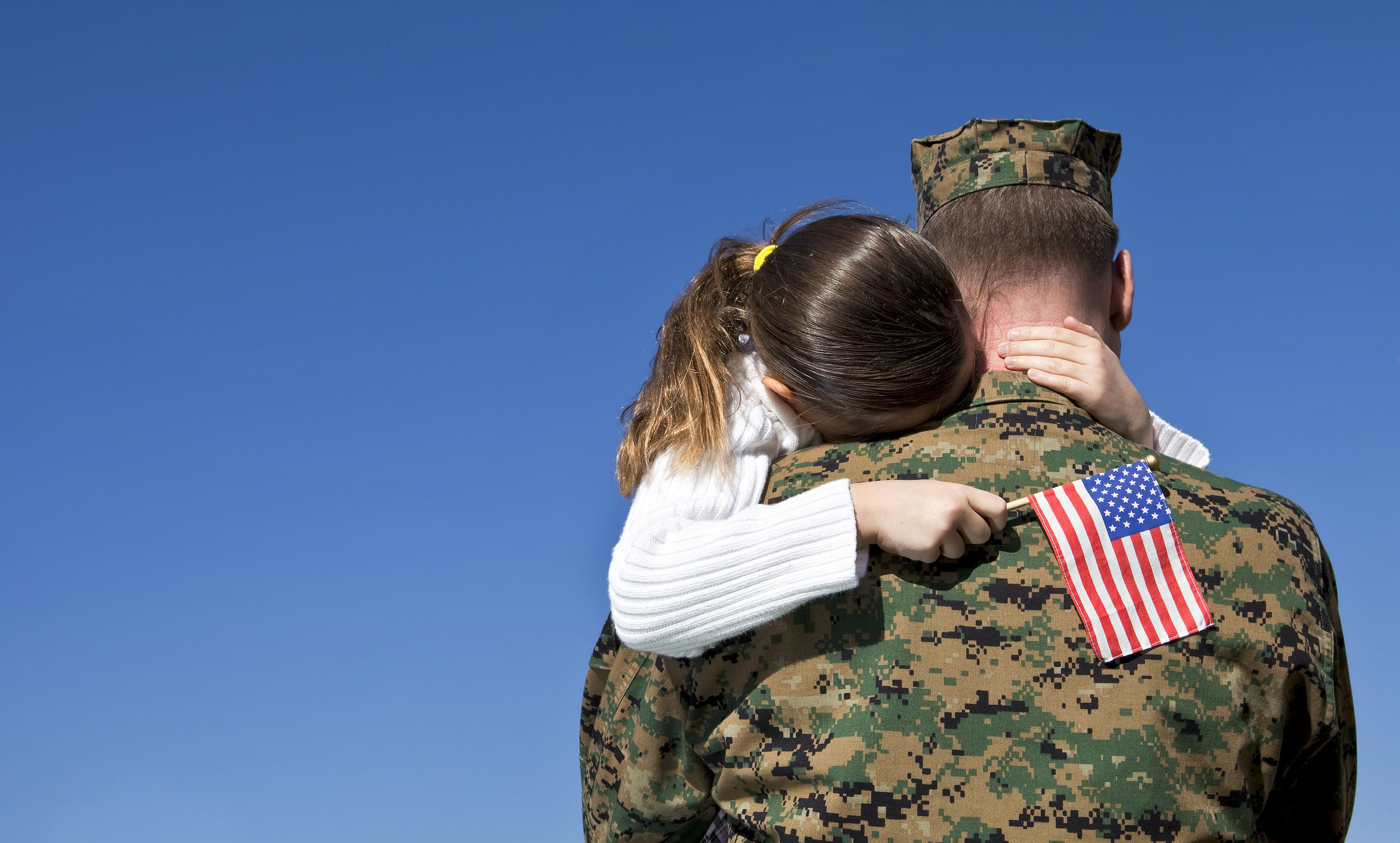 Service member holding his daughter